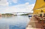 Restaurantes na beira do canal em Willemstad - Curaçao. Ao fundo, a famosa ponte Rainha Juliana